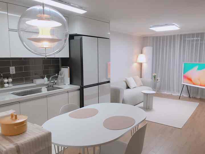 Bright and clean 20m² white-toned apartment living room and kitchen with simple modern style dining table and sofa
