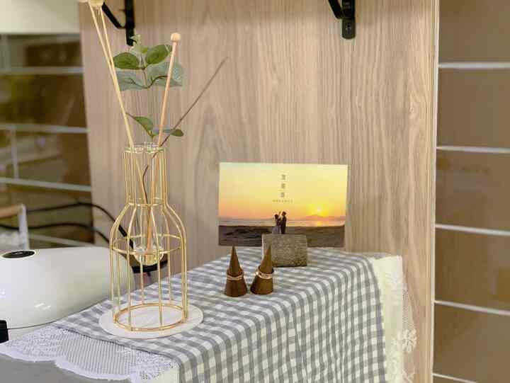 Natural-toned kitchen featuring a checked kitchen towel with gold diffuser and wedding invitation arranged for cozy ambiance