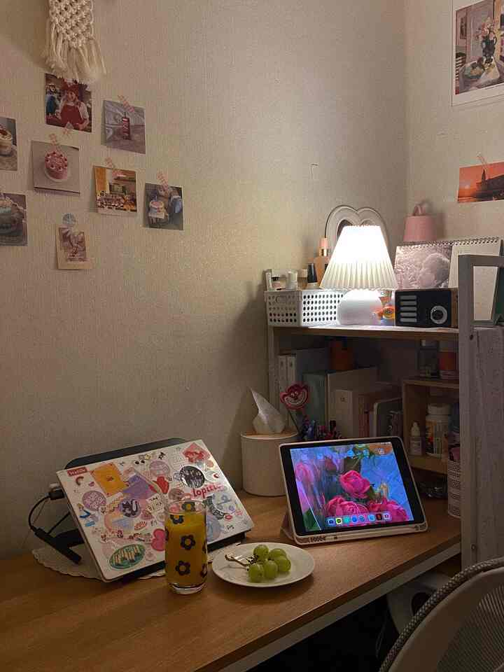Warm wood-tone lit single freelancer's bedroom workspace featuring a desk with laptop and tablet, creating a cozy atmosphere