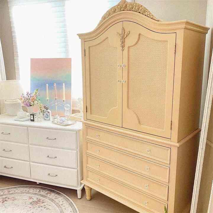 Natural and warm living space featuring beige wardrobe and white drawer cabinet