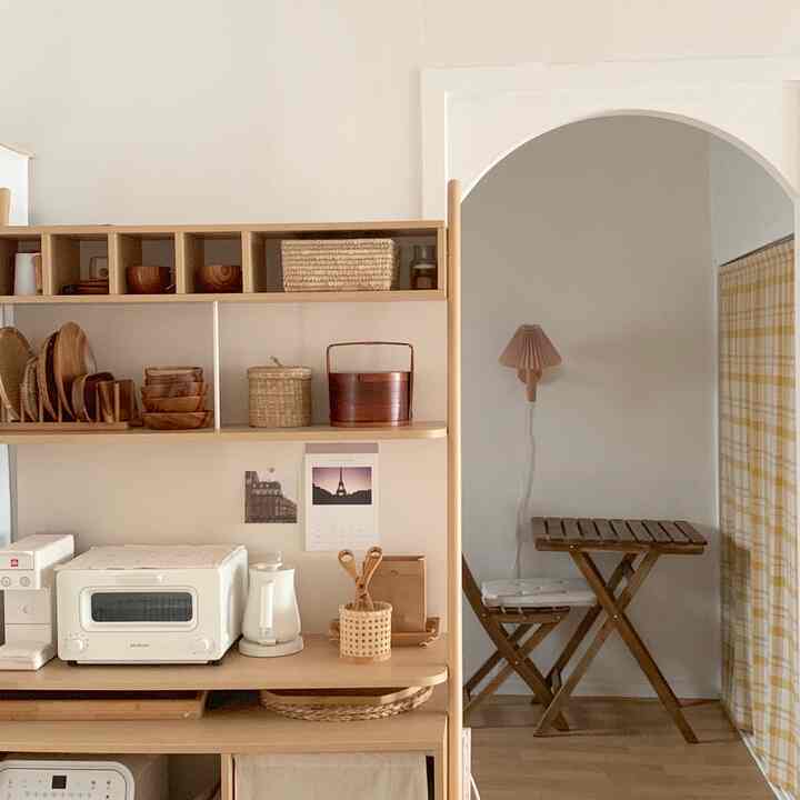 Natural wood tones and white blend in a home cafe kitchen space, featuring cozy and clean style