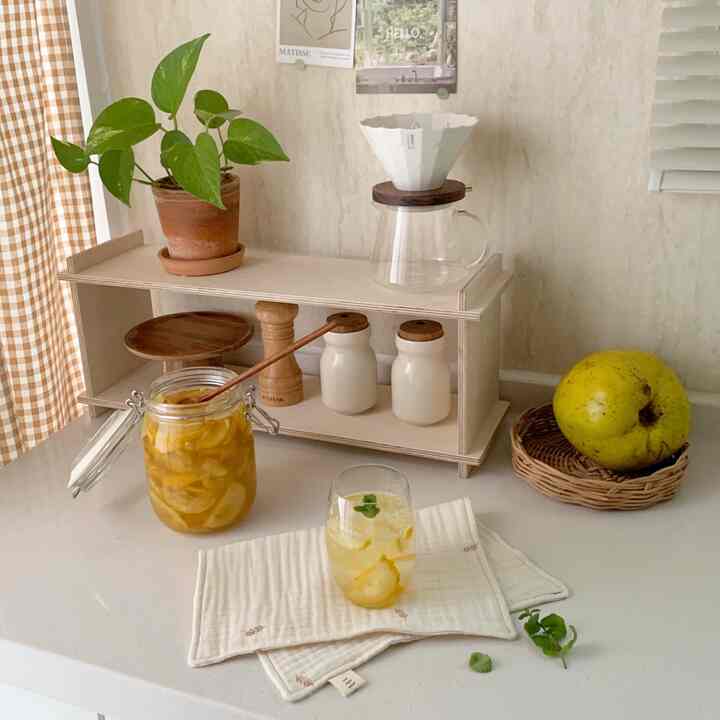 Yellow and natural wood tone kitchen featuring home cafe elements and a plant in a cozy atmosphere