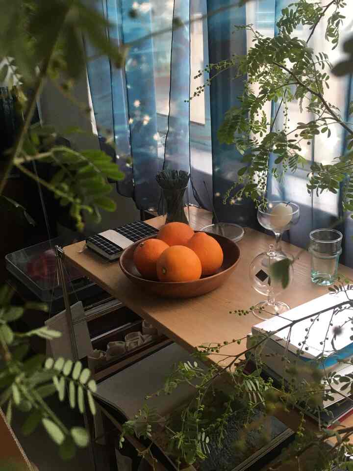 Wood tone and blue dining room featuring a natural atmosphere with a table adorned with oranges and a candle