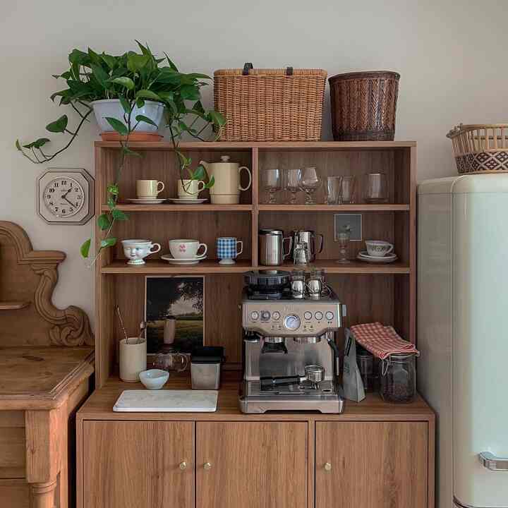 Cozy home cafe space featuring warm wood tone kitchen cabinet and coffee machine