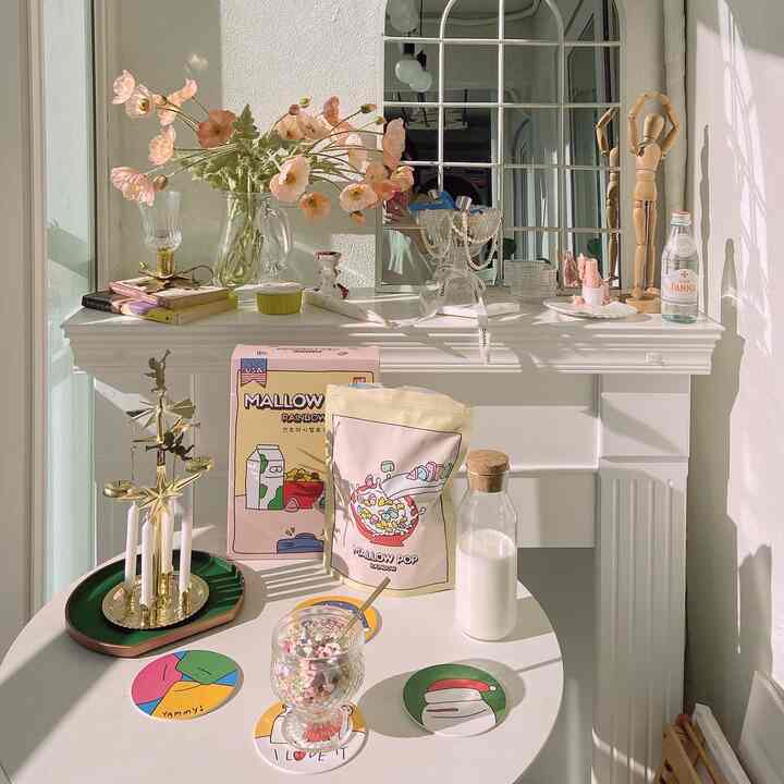 Bright white and beige toned veranda home cafe featuring floral vase and decor in a French Country style