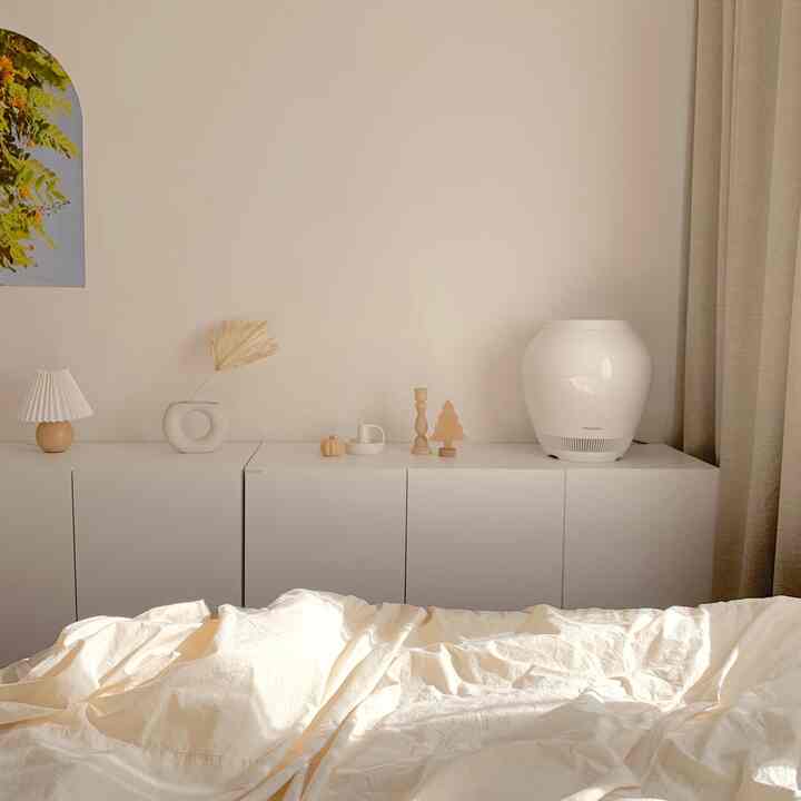 White and beige toned bedroom featuring neat cabinets and soft bedding creating a calm atmosphere