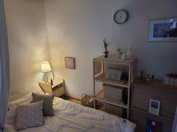 Natural color wood tone bedroom featuring bright wooden furniture and bedding with a warm and cozy atmosphere