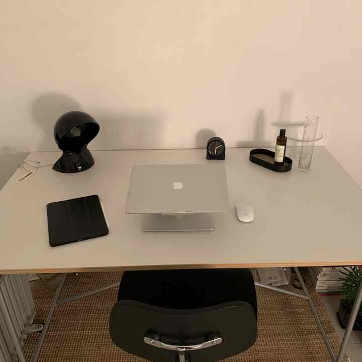Simple and modern home office featuring a white desk and black office chair