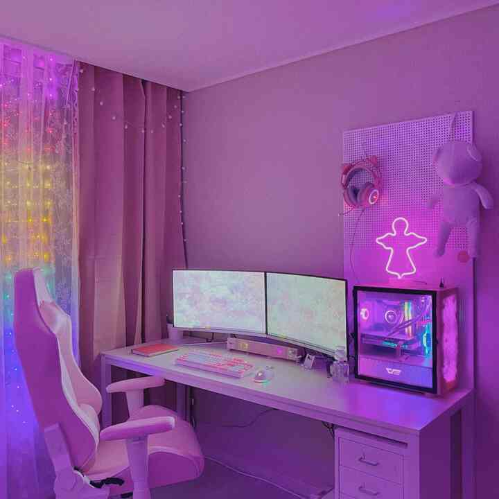 Pink and white toned home office game room featuring gaming chair and LED lighting in a modern setup