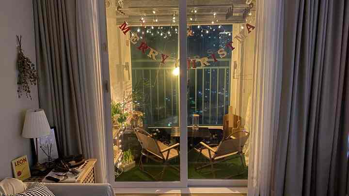 Warm-lit veranda mini home camping space featuring natural materials and cozy seating