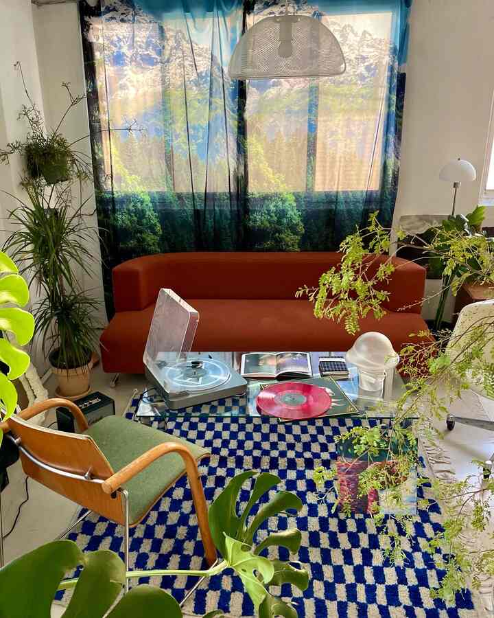 Blue and brown toned home office with green plants and a rug in a peaceful workspace