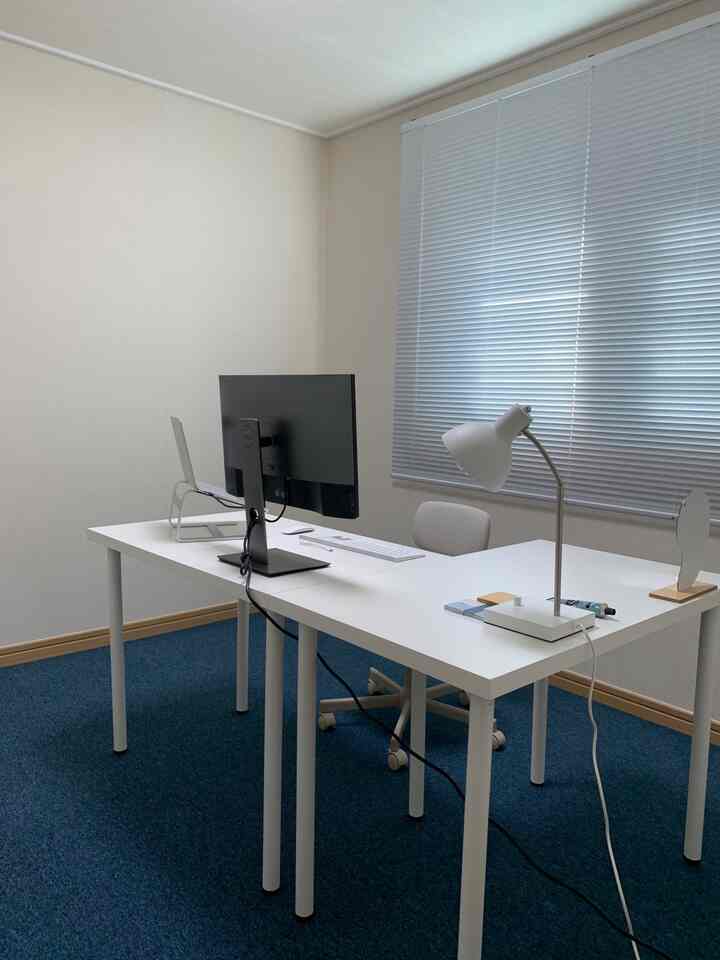 White and blue toned home office featuring a white desk and chair in a clean, simple modern interior