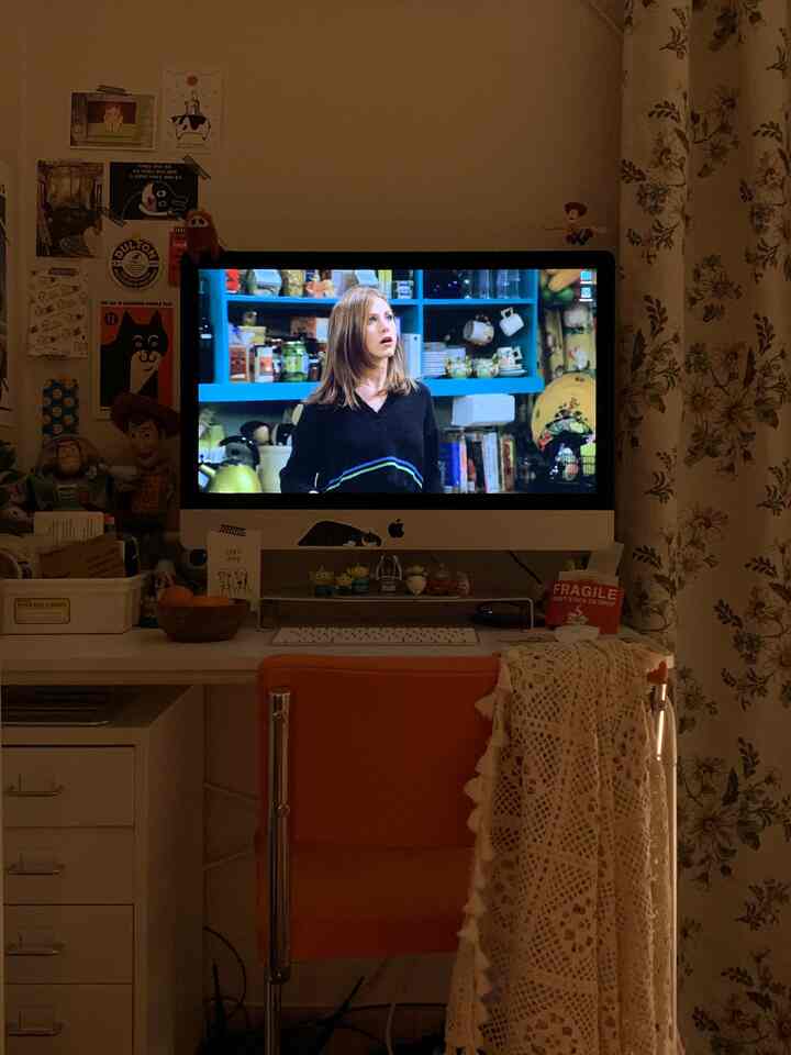 Beige and orange toned home office space featuring thick blackout curtains and vintage decor, creating a cozy ambiance