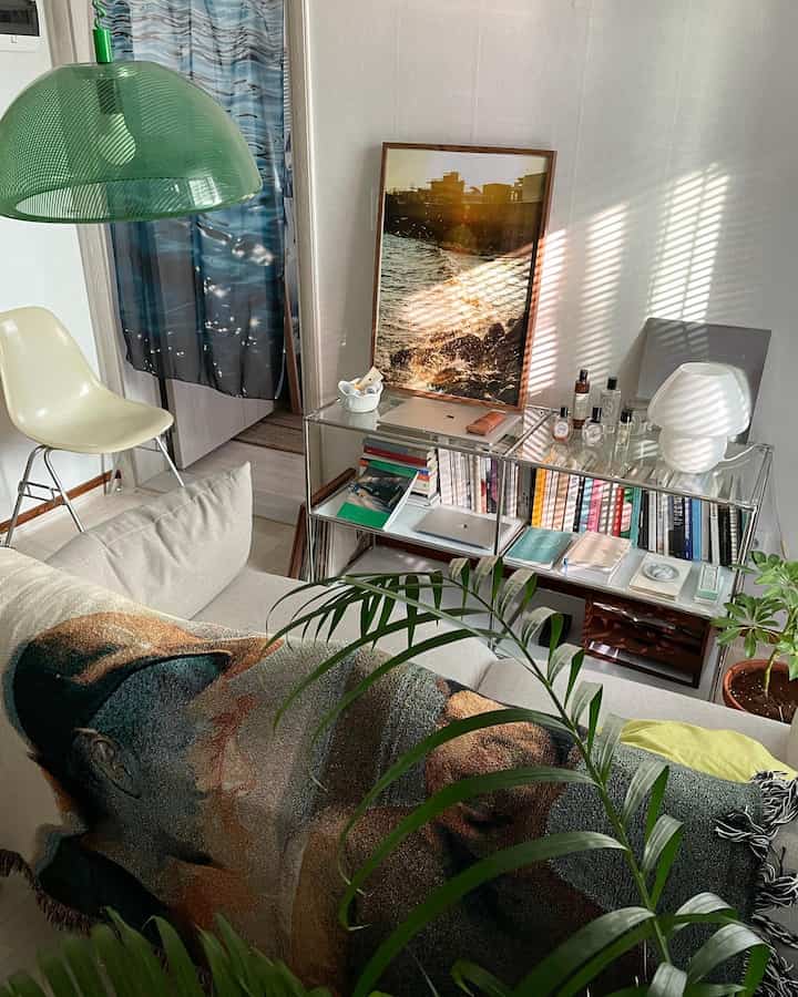 Beige-toned living room featuring sofa and bookshelf with natural, cozy interior atmosphere