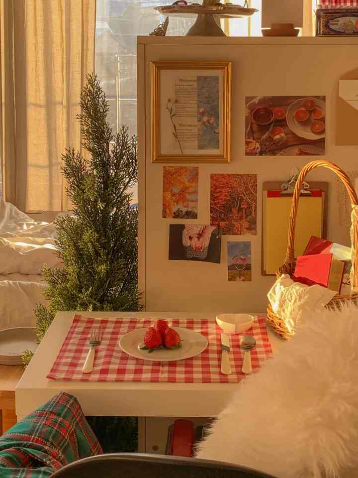 Warm beige natural living room featuring red gingham check tablecloth, rattan basket, and cozy home cafe atmosphere