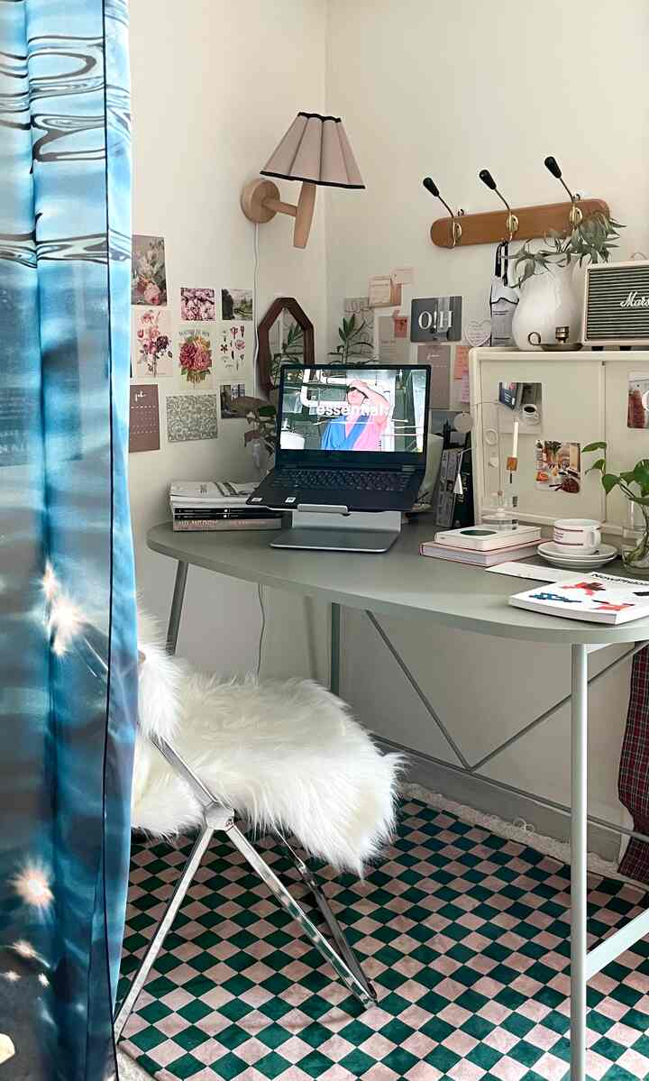 Home office space in white and green tones featuring a checkered rug and fluffy chair with modern desk interior
