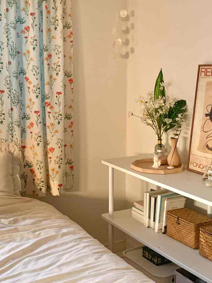 Beige and white toned loft bedroom featuring vases and storage baskets with a natural ambiance