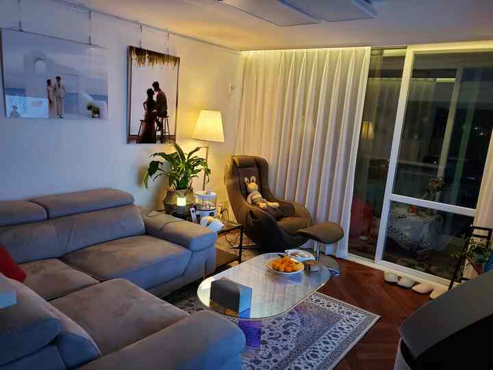 White-toned living room featuring a 4-seater sofa and Pause massage recliner chair creating a cozy atmosphere