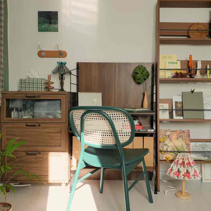 Wood tone and natural color home office study space featuring a desk, bookshelf, and storage cabinet with cozy atmosphere