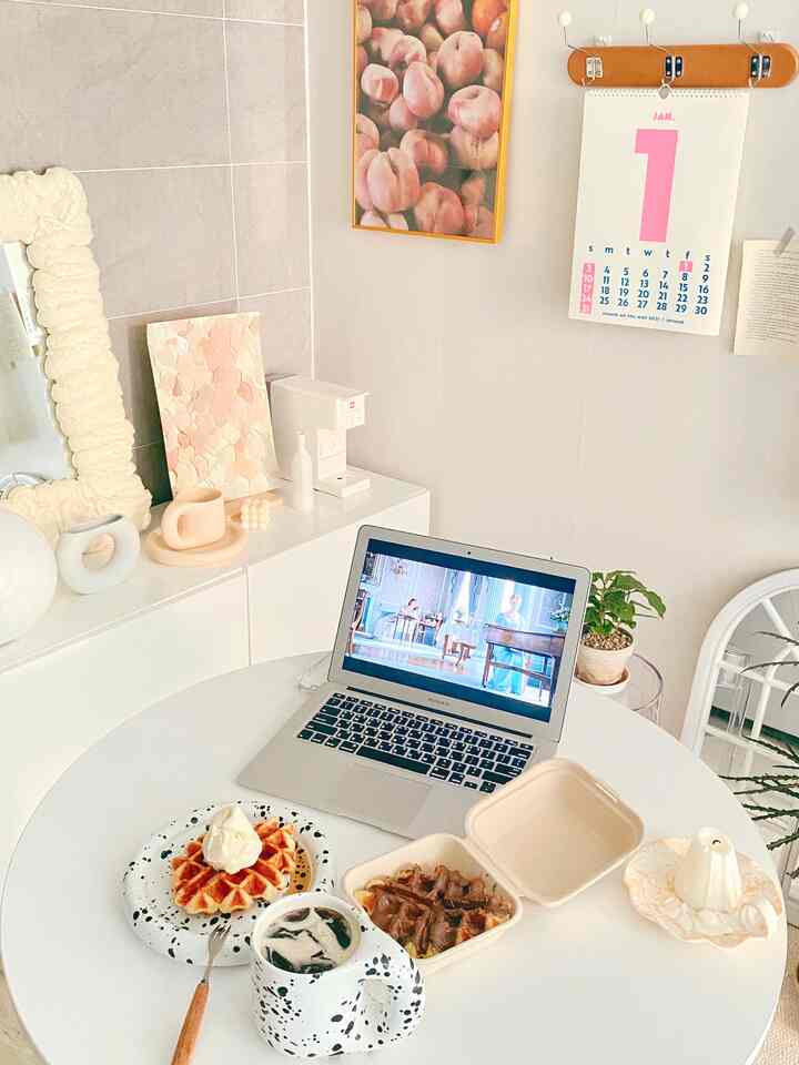 Cozy and simple home cafe space with round white table and beige decorative accents