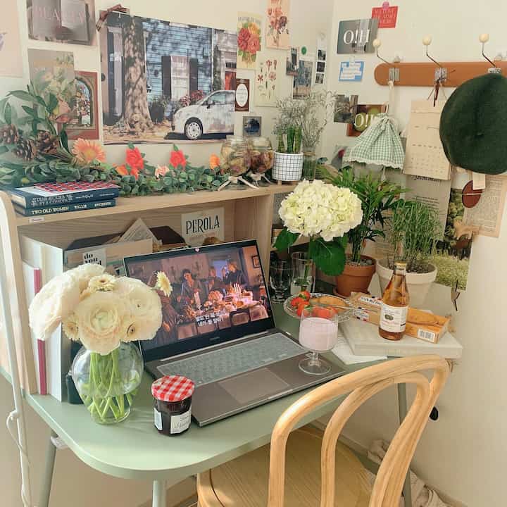 Natural-toned home office space featuring a desk adorned with vases and posters for a cozy desk decor