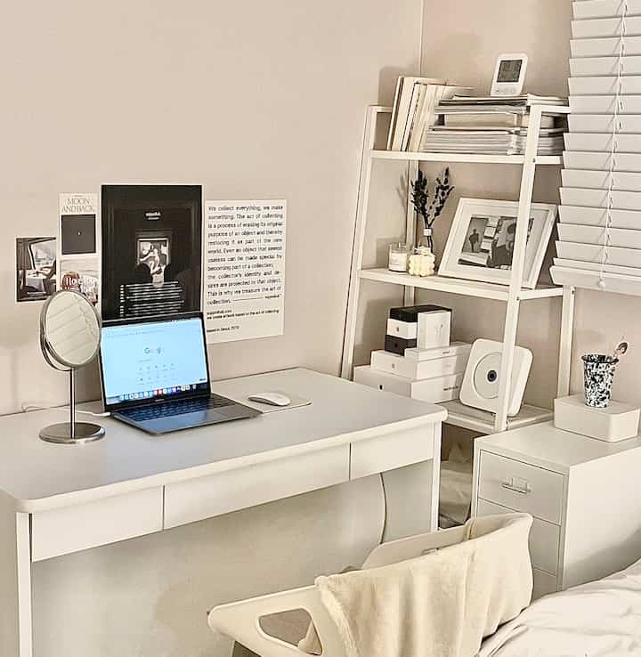 White-toned small room home office featuring a clean desk, storage units, and a simple, comfortable atmosphere
