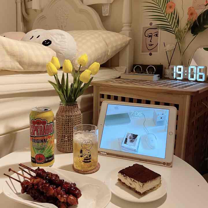 White and beige toned 6-mat room, cozy single household space with a round table holding late-night snacks and an iPad