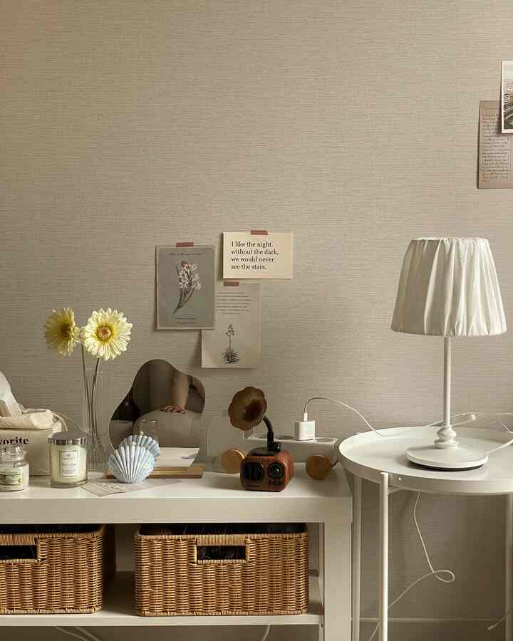 Natural color space with beige walls, wood rattan baskets on console table, and a white table lamp on side table creating cozy ambience
