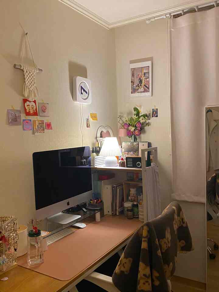 Cozy white and beige small powder room combined with home office, featuring computer desk and vanity with warm atmosphere