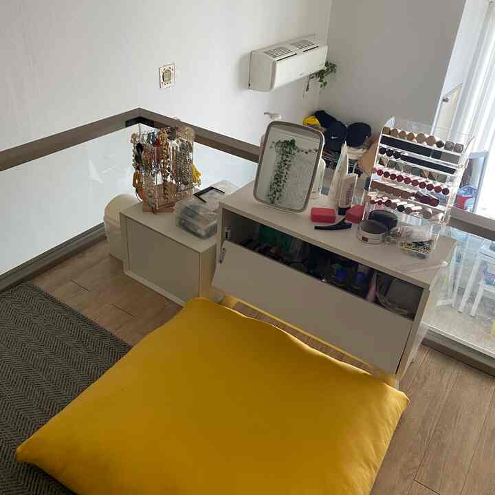 White and wood tone loft space featuring a floor seating vanity with a large yellow cushion creating a cozy atmosphere