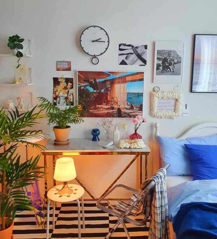 White and blue toned bedroom featuring a console table and posters with a European romantic vibe