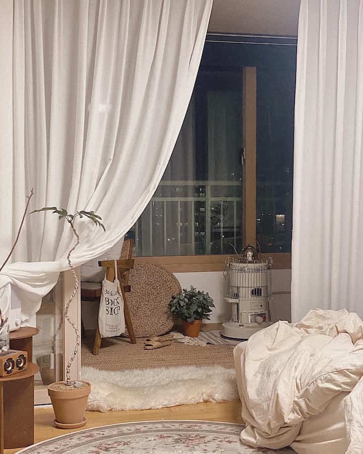 Ivory-toned veranda featuring powder butterfly pleated curtains, rugs, and plants in a natural and cozy interior