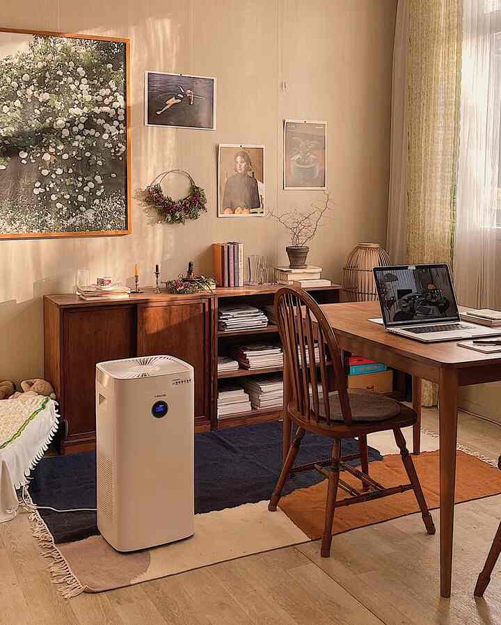 Beige-toned home office featuring wooden furniture and a centrally placed air purifier with a cozy interior