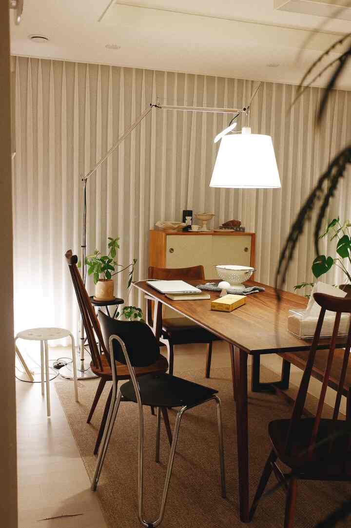 Natural wood tones and white lighting in dining room, creating a warm and cozy atmosphere