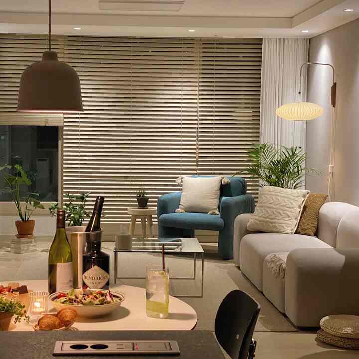 Warm-toned living room with beige sofa and blue armchair creating a cozy space