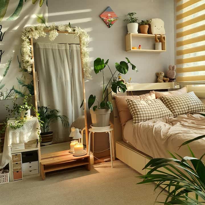 Beige and wood-tone bedroom featuring various plants and charming decor, creating a natural and warm atmosphere