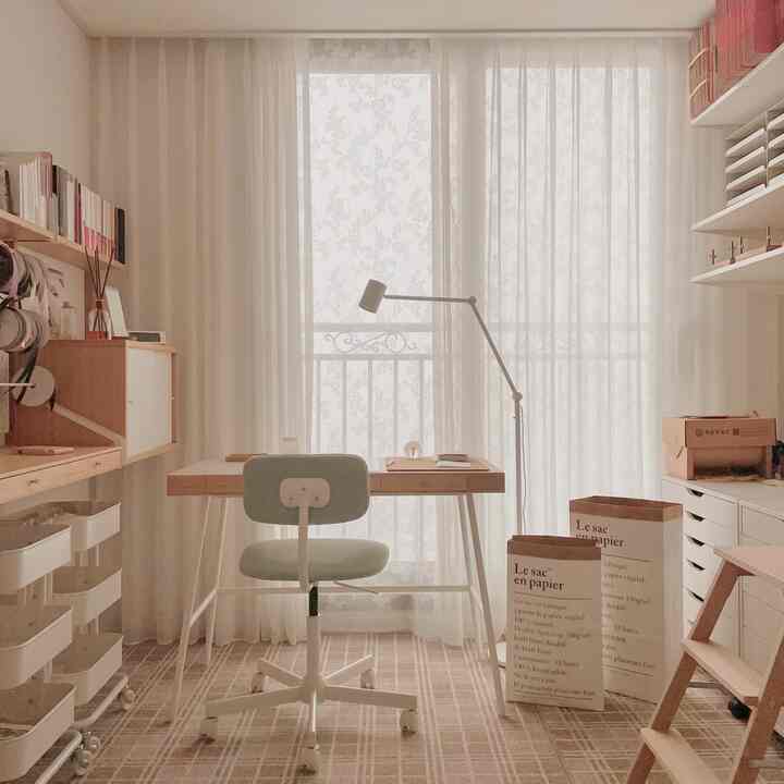 Bright study with white and wood tones, featuring a desk, chair, and sheer curtains for a clean atmosphere