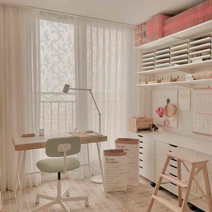 A natural and white-toned home office featuring organized storage solutions, a check-patterned rug, and a calm, tidy atmosphere
