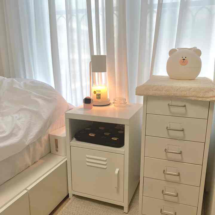 White-toned bedroom featuring a bed, nightstand, and dresser creating a cozy atmosphere