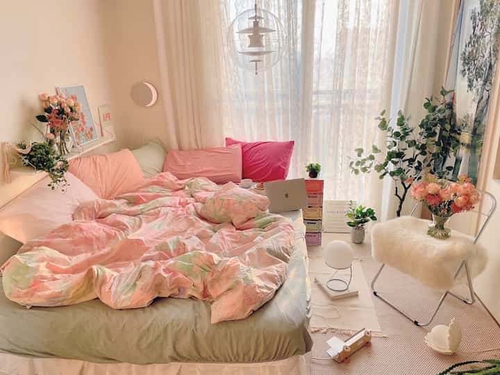 Pastel tones and natural cozy bedroom featuring a bed and decorative vases arranged harmoniously