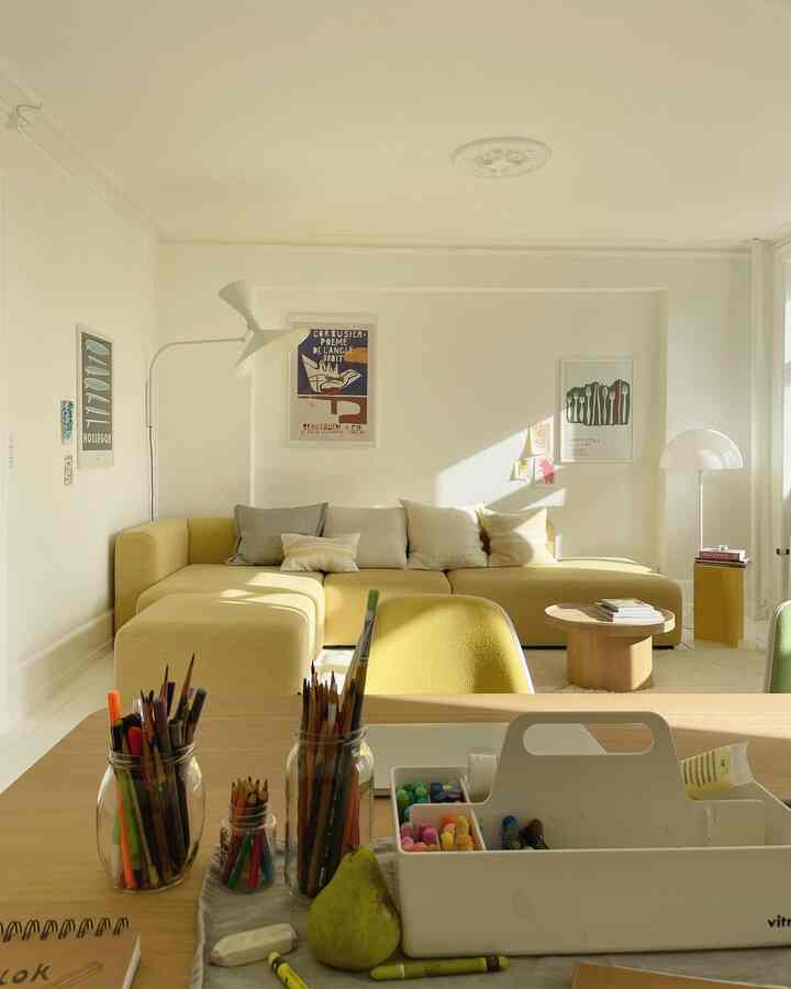 Bright Nordic living room with yellow sectional sofa, wooden coffee table, and natural sunlight filling the space