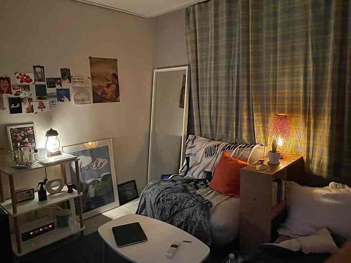 Natural toned cozy living room featuring a sofa bed and wood-tone furniture creating a warm evening ambiance
