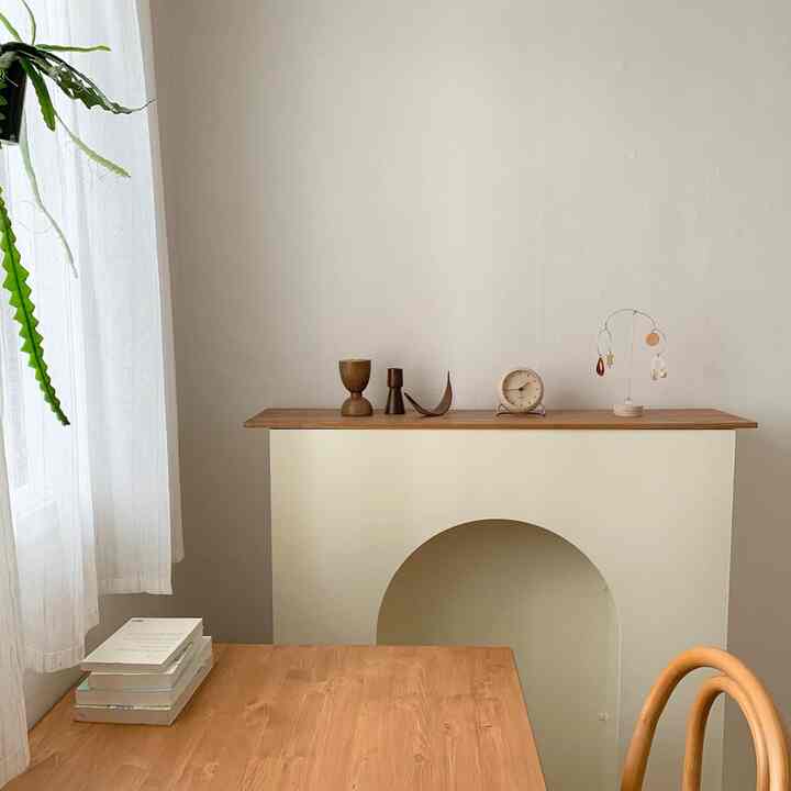 Wood tone and white living room featuring simple, natural furniture and minimal decorative elements