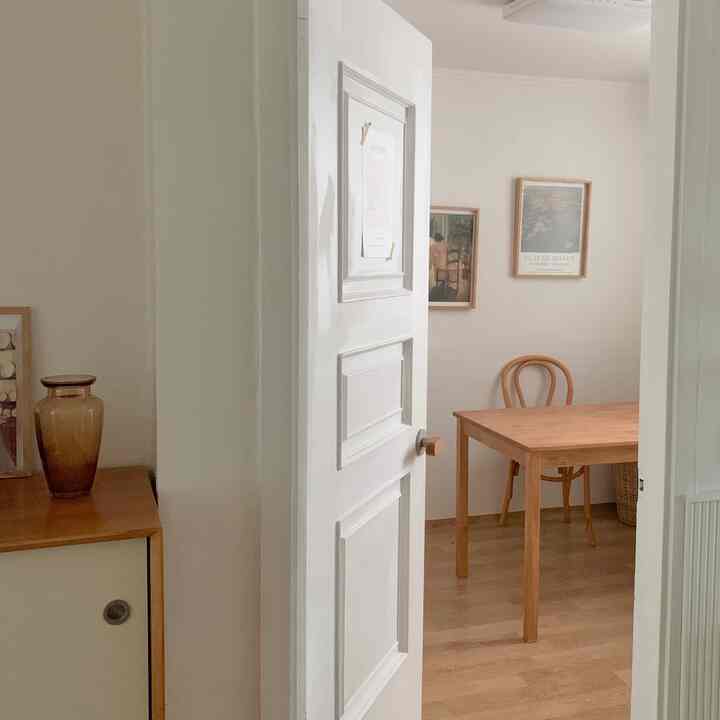Cozy study space with soft white walls and natural wood furniture, featuring a clean and natural ambiance