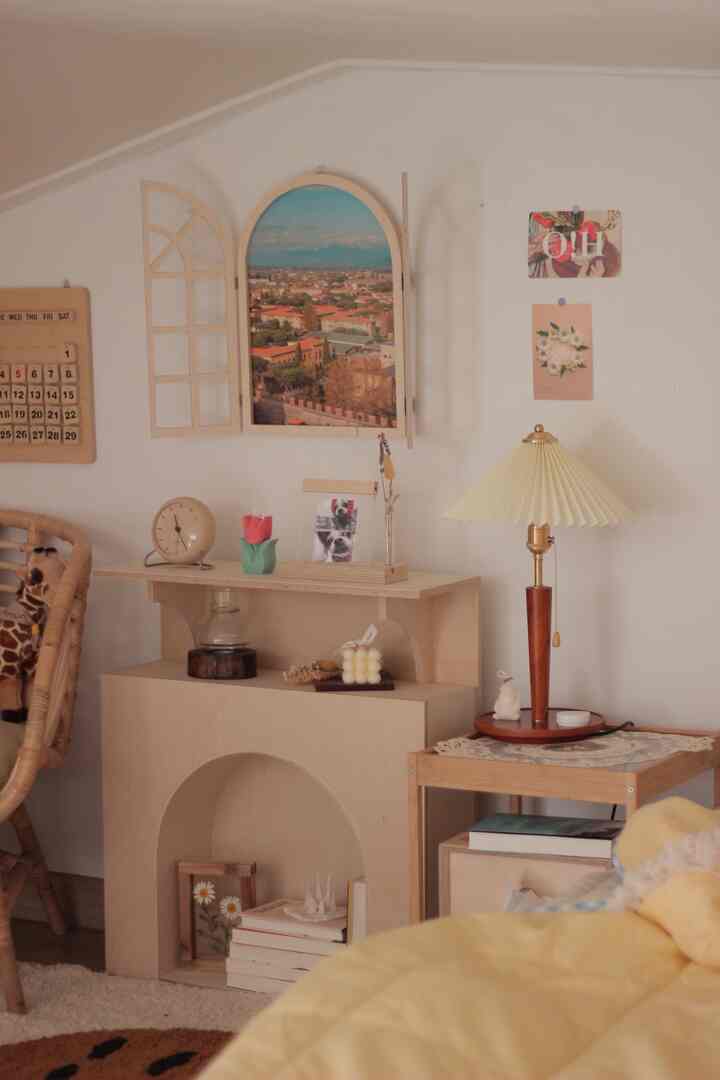 A cozy loft living room with wood tones and yellow accents, featuring an arched window, mini fireplace, and table lamp