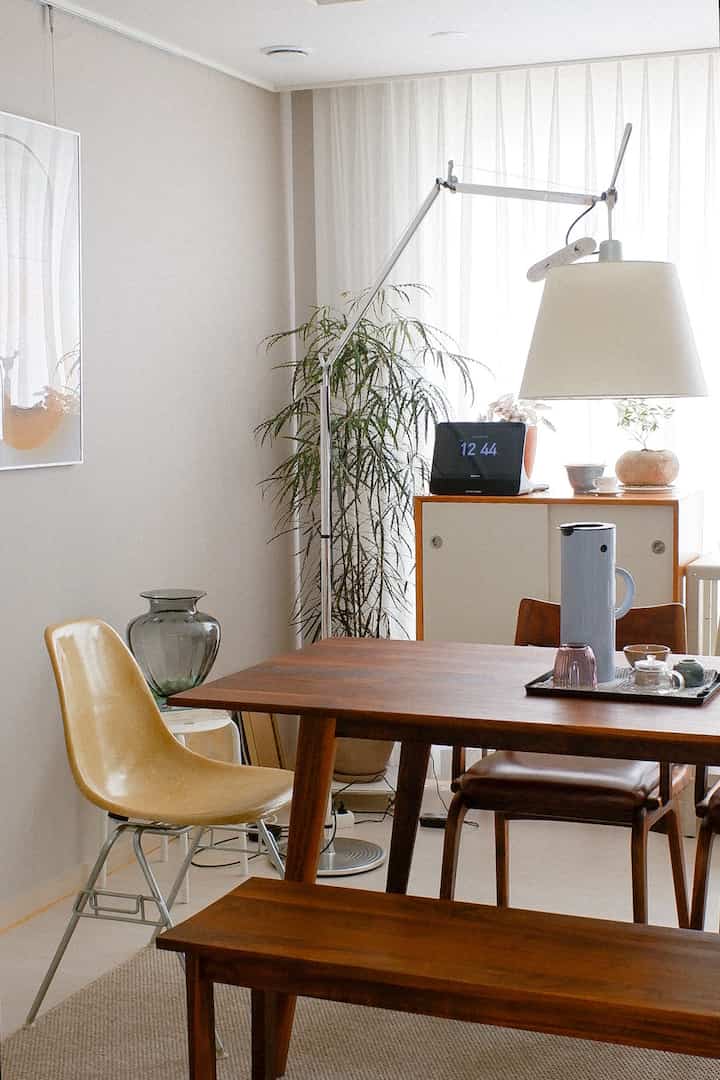 Natural-tone dining room with brown wood furniture and white curtains