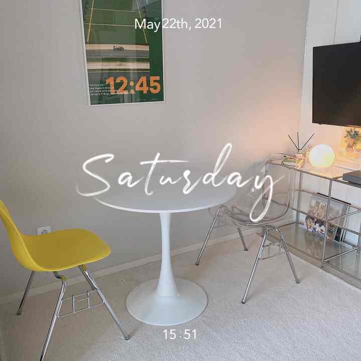 White and yellow toned dining room featuring a round dining table with transparent and yellow chairs, creating a clean atmosphere