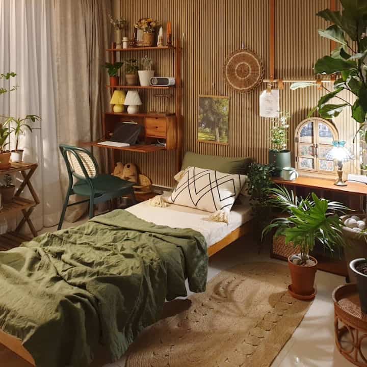 Natural wood-toned bedroom with green accents featuring a daybed and rattan furniture in a cozy setting