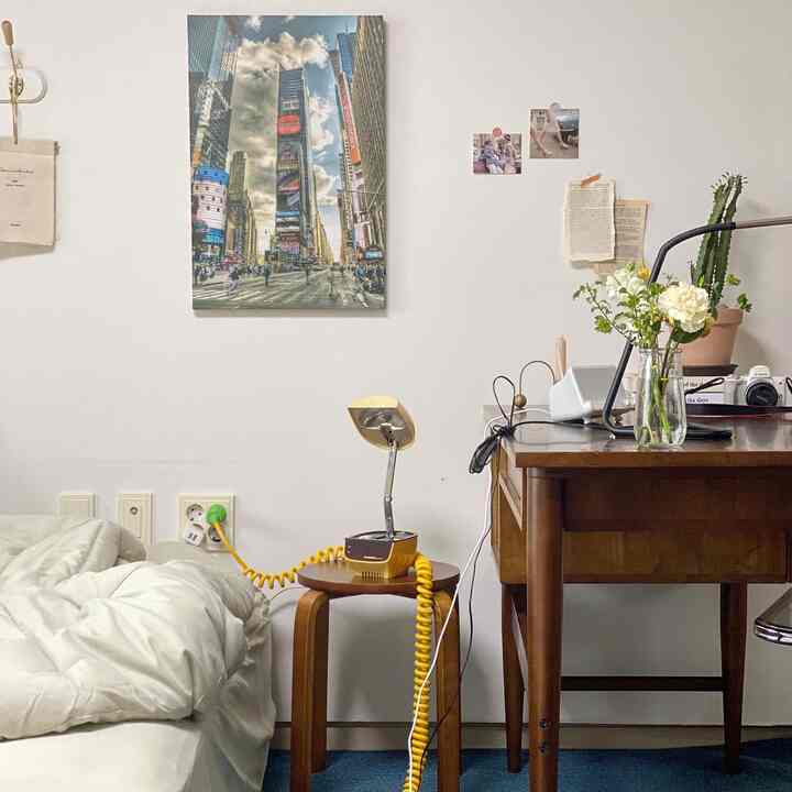 White-walled bedroom with brown wooden furniture in a compact single household space, cozy and natural atmosphere