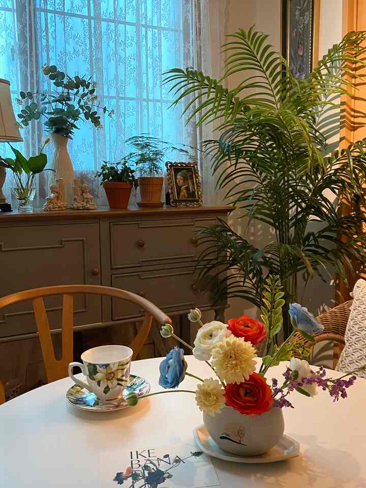 Natural tones featuring a white round dining table, rattan chair, and diverse plants in a cozy study and workspace